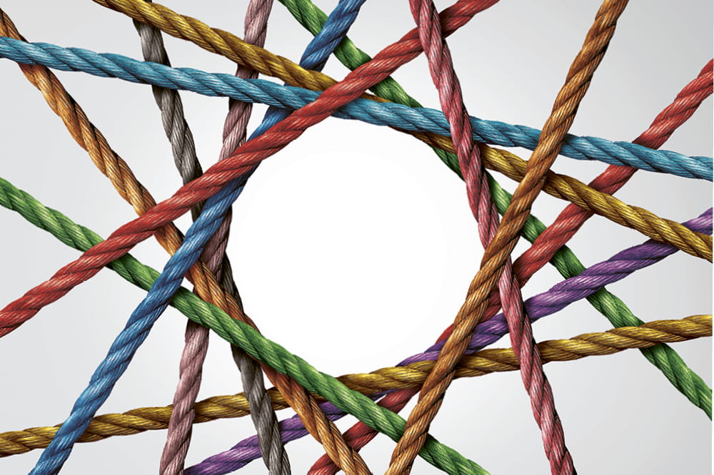 A net of different coloured ropes that form a circle in the middle. Copyright: iStock/wildpixe